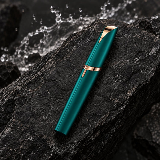 Astrella facial hair remover — green — capped device on stone